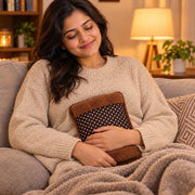 Woman using electric hot water bag for period cramp relief