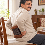 Man using electric hot water bag for lower back pain relief