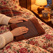 Electric hot water bag on a quilt for winter warmth